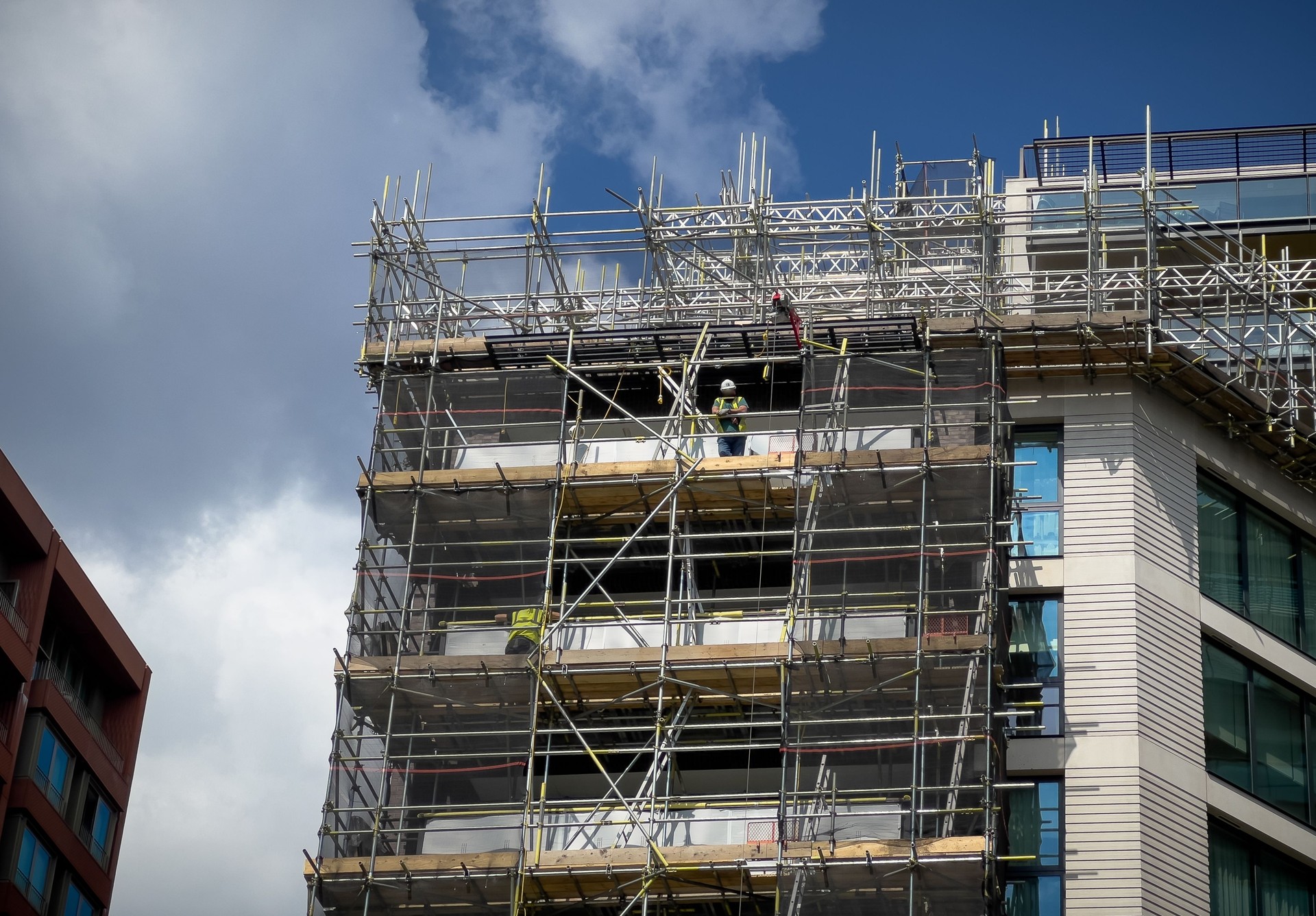 Construction workers on building site and development in the city